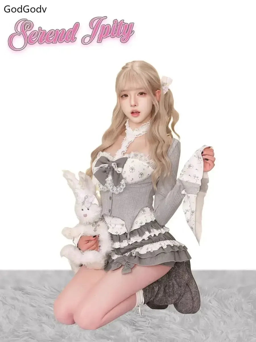 Sheer Lace High-Neck Top, Ribbed Cardigan Shrug, Lace-Up Bow Corset Vest, & Tiered Ruffle Mini Skirt with Cross Detail Set