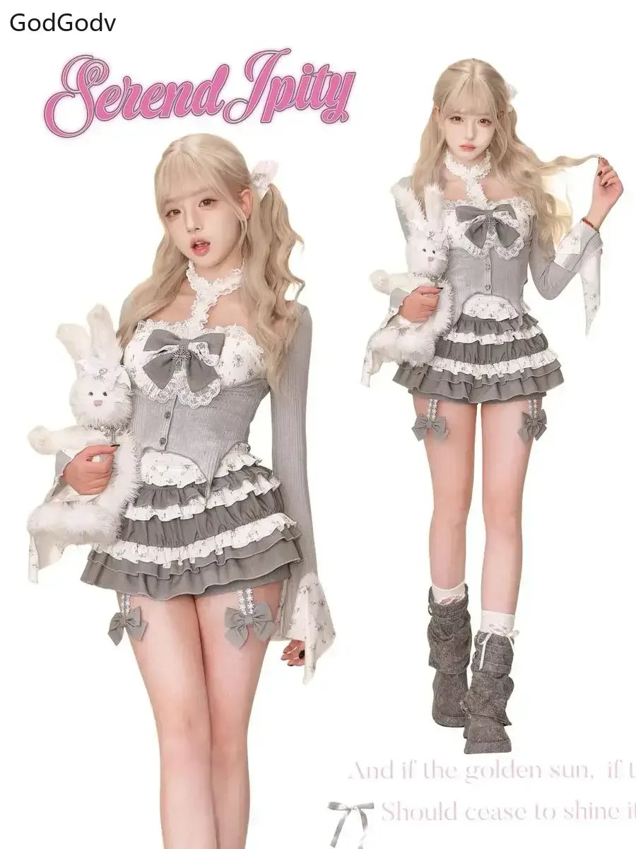 Sheer Lace High-Neck Top, Ribbed Cardigan Shrug, Lace-Up Bow Corset Vest, & Tiered Ruffle Mini Skirt with Cross Detail Set