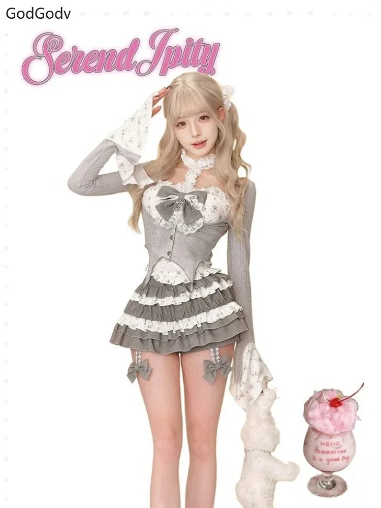 Sheer Lace High-Neck Top, Ribbed Cardigan Shrug, Lace-Up Bow Corset Vest, & Tiered Ruffle Mini Skirt with Cross Detail Set